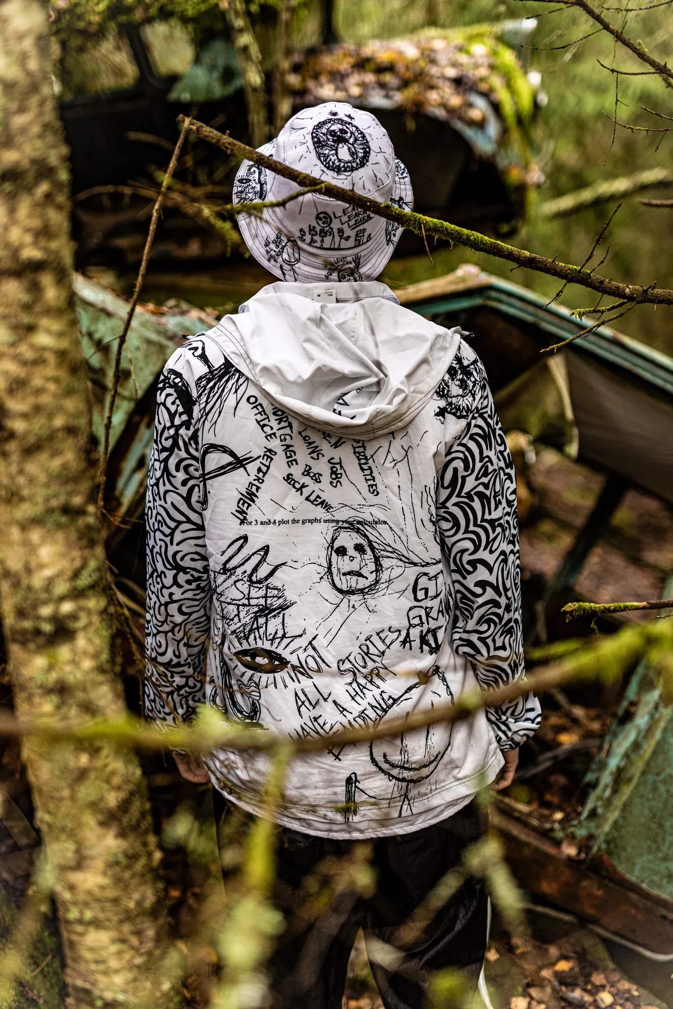 From behind: the OG bucket hat and the Infinity windbreaker among the trees