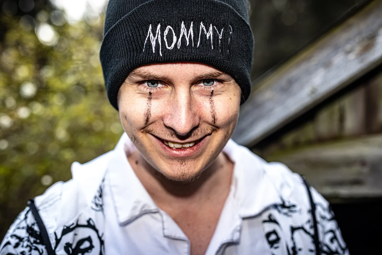 Close up: a grinning young man in the black Mommy? beanie