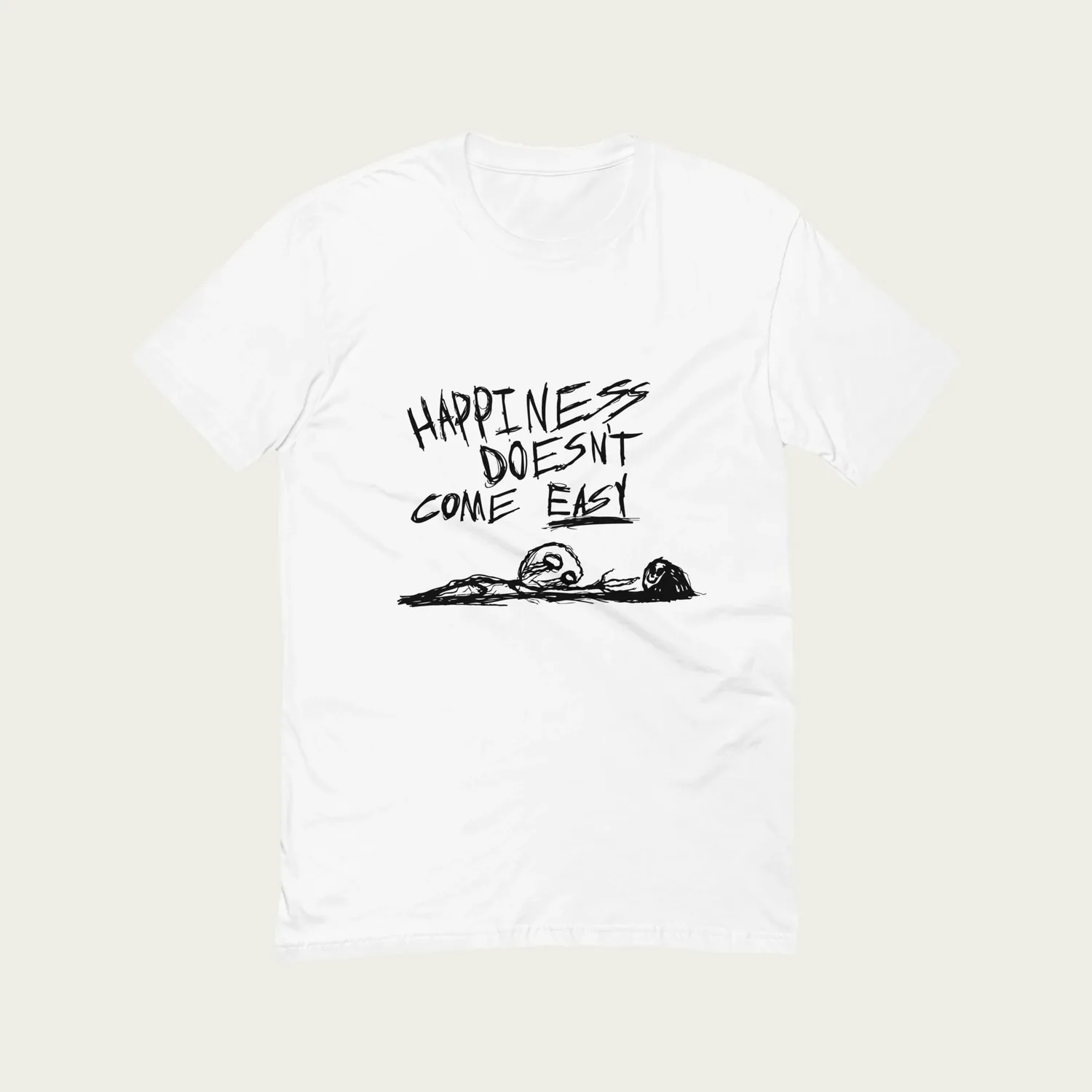 A white T-shirt printed with Happiness doesn’t come easy above a small figure lying flat on its face
