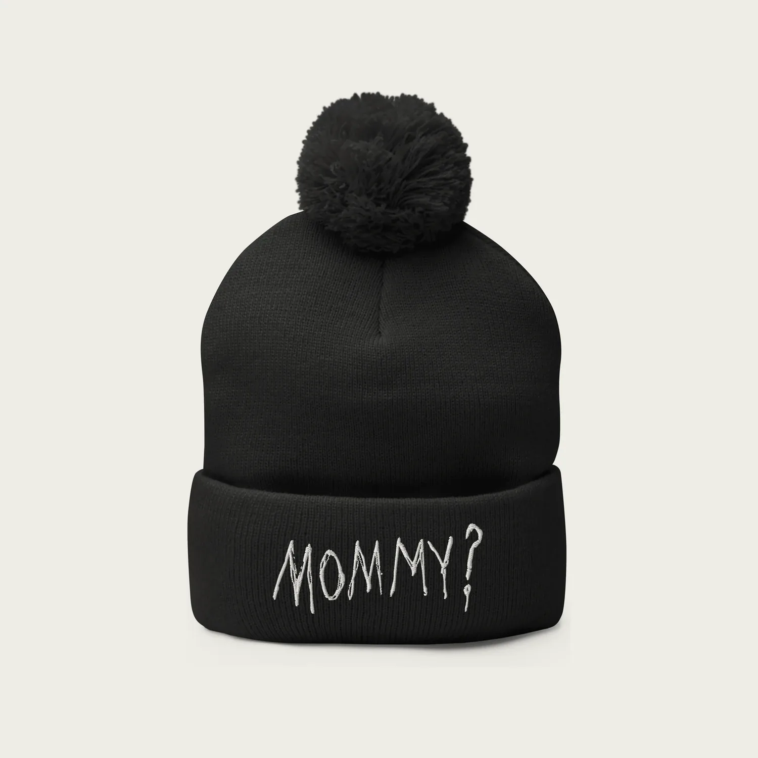 A black knitted beanie with a pom-pom and the word Mommy? embroidered in white on the cuff